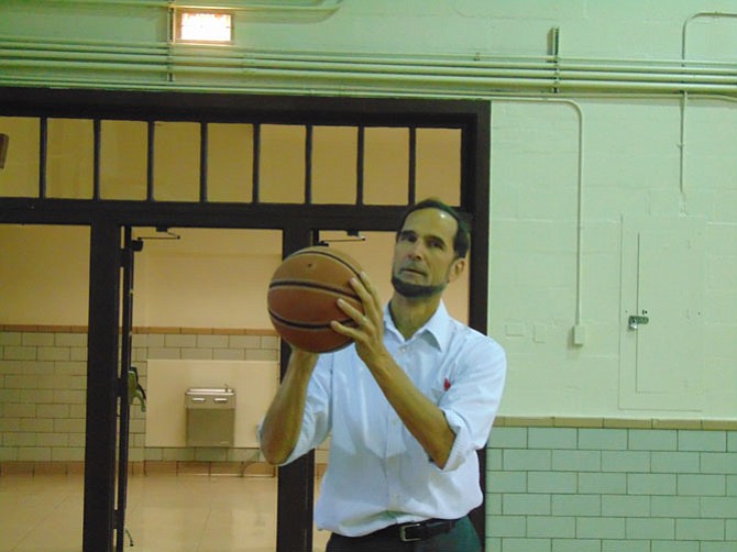 Mount Vernon District Supervisor Dan Storck tries out the basketball court at the Teen Center.