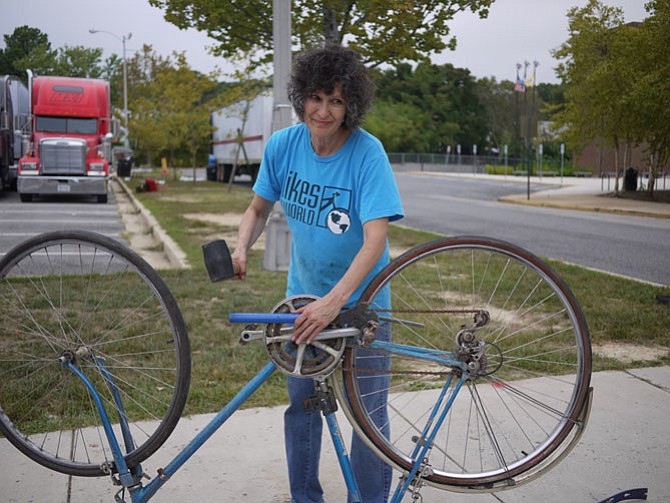 Helen Gelband takes apart a bike to put in the last truck of the day — the third truck they filled with donated bikes. She occasionally works overseas within the group “Wheels of Africa” which helps promote a bike culture and keeps people able to work and go to school when they have no other transportation.  
