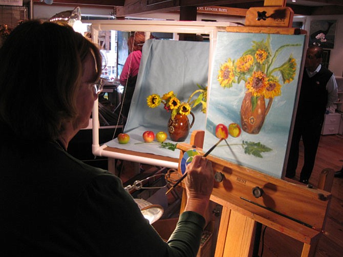 Carol Howard with her piece, Sunflowers, at The Artists' Atelier in the Village Green.
