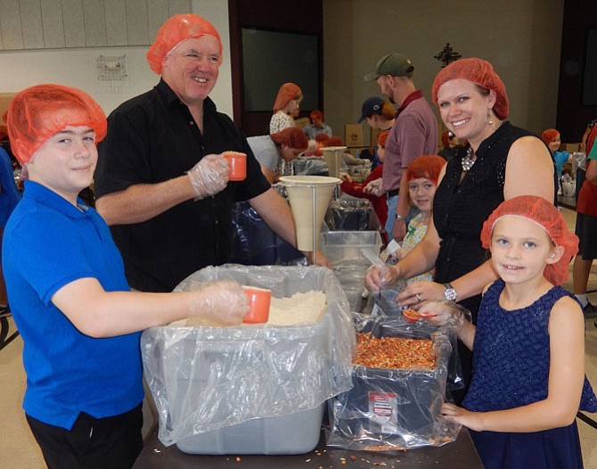 Measuring food for the meal packets are (from left) Brian Hesse, 11; Dwane Evans; Janie Hesse, 7; Johannah Evans and Samantha Evans, 7.
