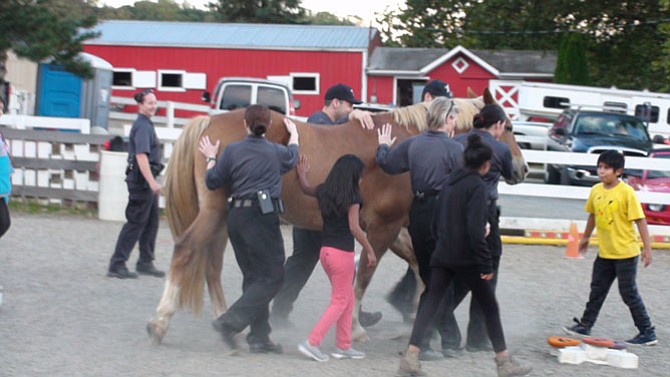 On Oct. 14, more than 12 deputies from the Sheriff’s Office spent time with at-risk youth from Alternative House in a pilot partnership program for community engagement at the Northern Virginia Therapeutic Riding Program farm in Clifton.