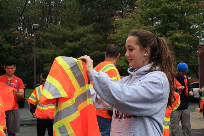 Hannah Todd dons a reflective vest before heading out to clean up the road named after her father.