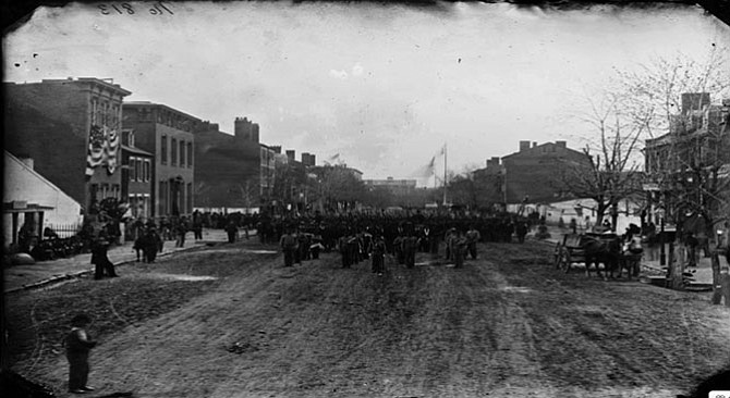 Union Troops stand on an unpaved street in D.C. before Gov. Alexander "Boss" Shepherd’s work was completed. 