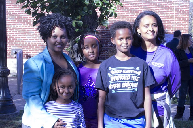 Family Affair: Mother Fegegta Workie (far right) brings her children, (right to left) Abaineh Haile, Naomi Haile and Helina Haile to the poll with her to watch her cast her vote for the first female presidential nominee of the Democratic Party. They ran into their “auntie,” Essey Workie, who was also voting (far left). 