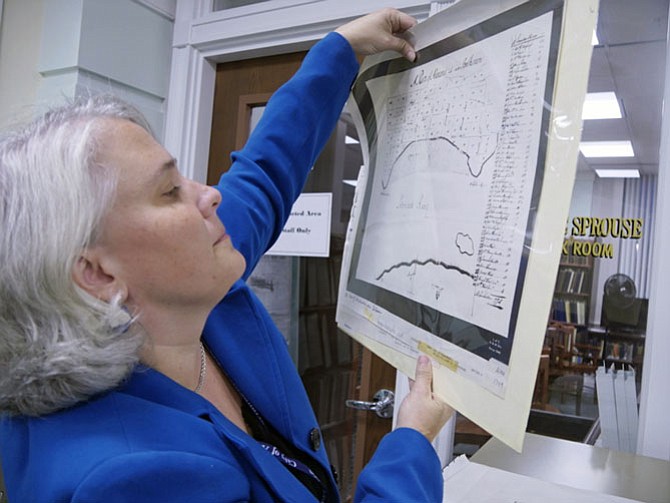 Tricia Walker pulls out a drawer of maps — Presbyterian Cemetery, Alexandria to 1760. A number of people are researching the history of their homes.