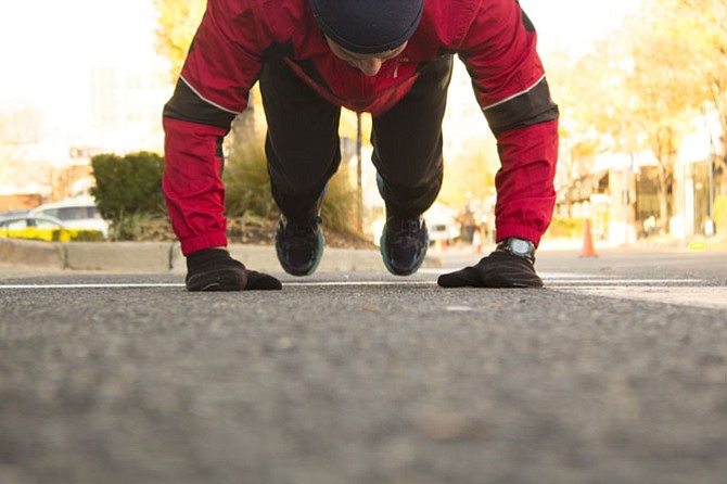 Christopher Scalia, 40, of Fairfax stretches before the race. He ran for his brother who serves in the Army and finished in 20 minutes and 46 seconds.
