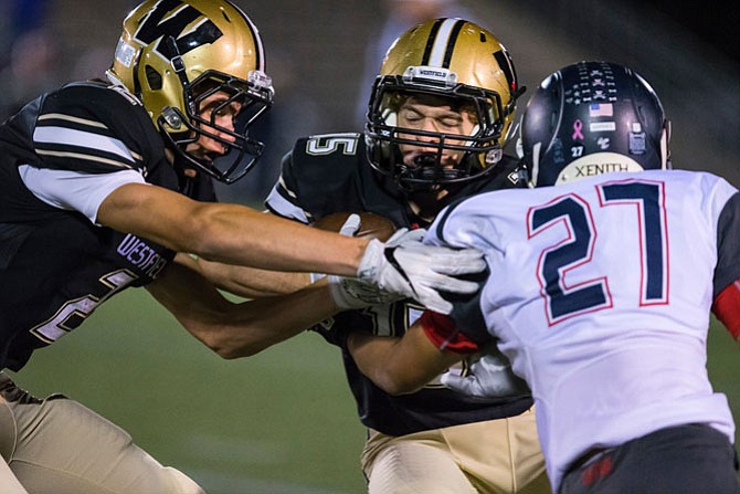 Sean Eckert # 2 treis to hold off WT Woodson defender Isaiah Barnes #27 after teamamte Gavin Kiley's #15 reception.