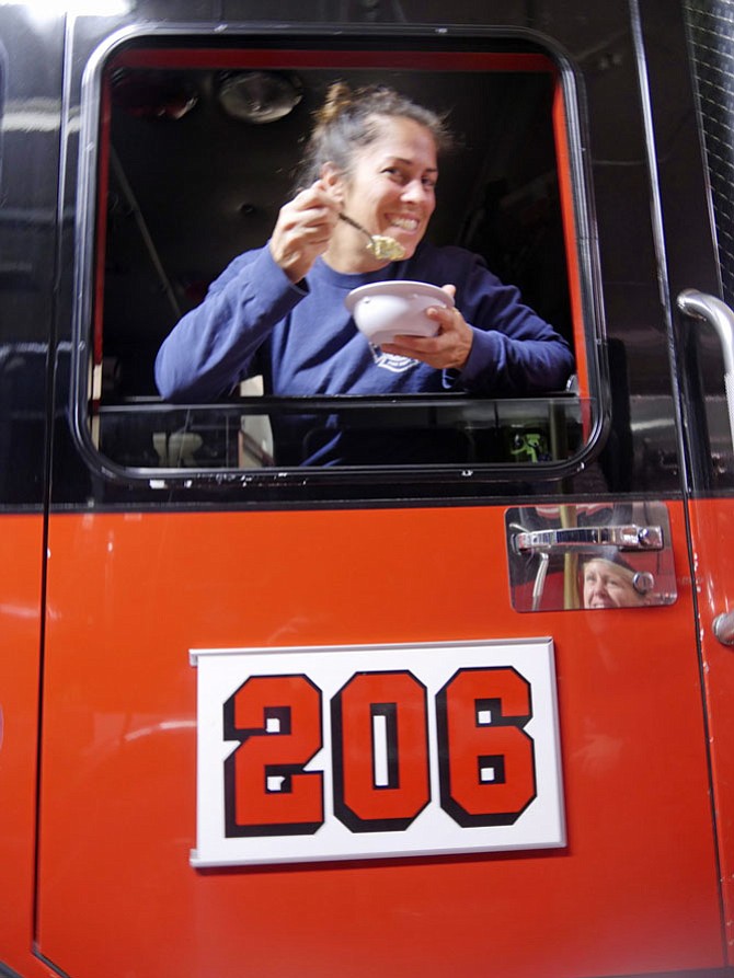 Kristina Holt from Station 206 on Seminary Road is winner of the City of Alexandria best firefighter chef contest. She shows off a bowl of her one of the favorite meals: chicken corn chowder.