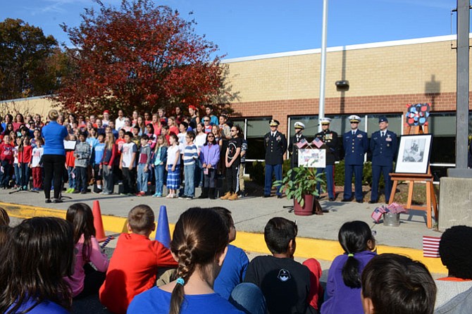The Sangster choir and handbells performed “On Veterans Day” by Karl Hitzemann, as well as the national anthem while the military personnel on hand raised the American Flag on the school’s flagpole.