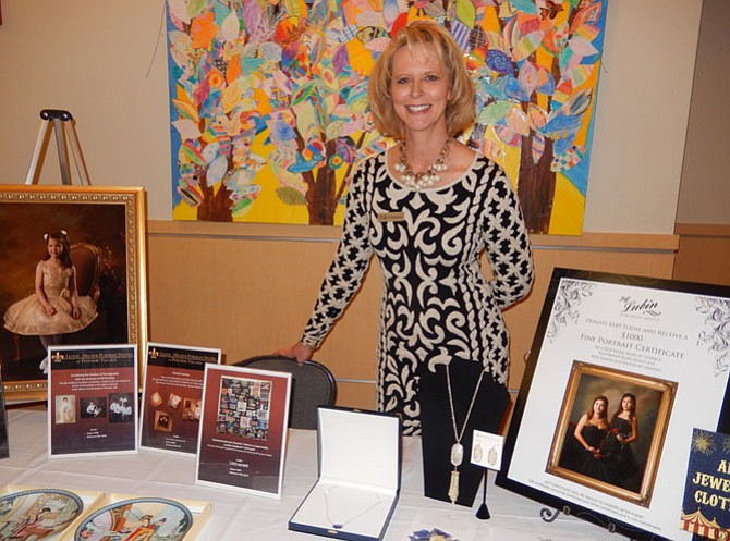 Daina Hart mans the silent auction’s art, jewelry and clothing table.
