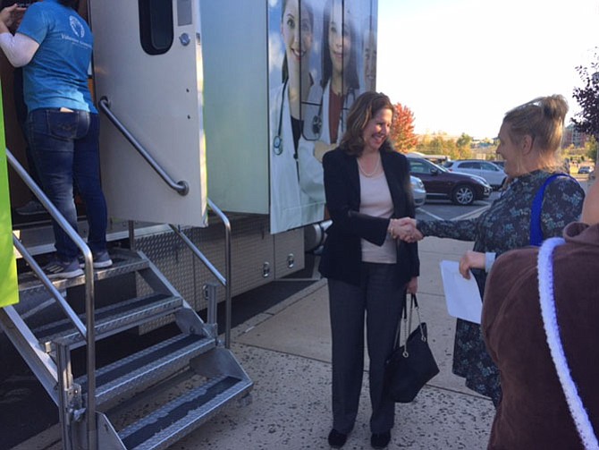 Mayor Allison Silberberg greeted Olenia "Kay" Haley, who used the opportunity to learn about Obamacare and sign up; she got blood work done and tested her glucose and cholesterol levels.