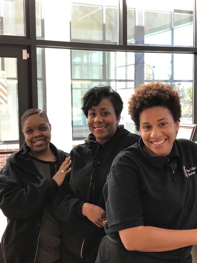"Every day [at The Ultimate Barber] is a grand opening,” says employee Patrice Wright. From left are Monikk Miller, receptionist; Patrice Wright, manager; and Melanie Thomas, barber. Women are a growing influence in the field of barbers, according to John Hall, owner of The Ultimate Barber.