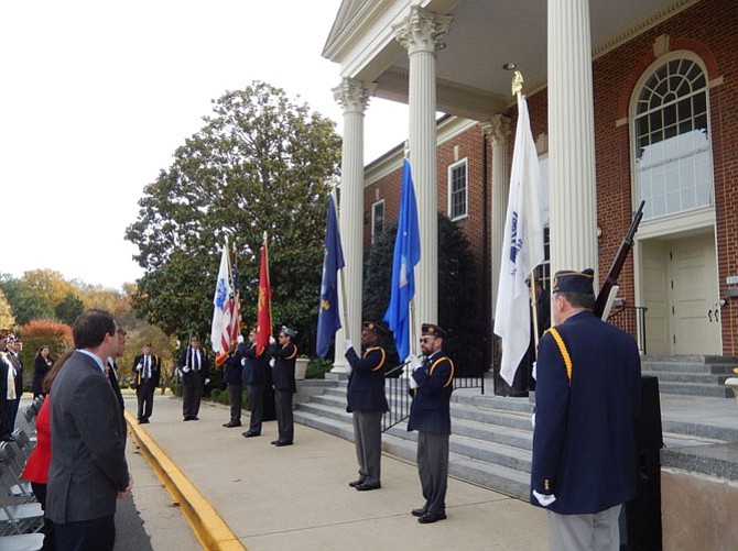 Attendees standing for the color guard.
