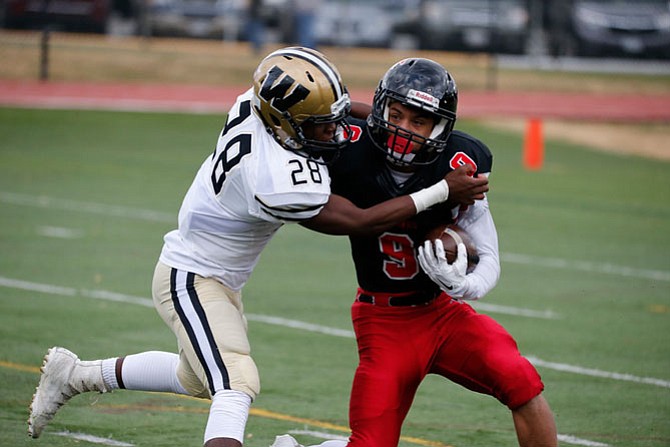 Westfield's Israel McClain #28 tries to bring down Madison's Landan Thomas #9