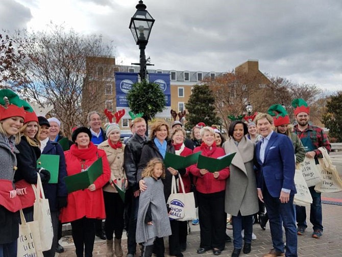 U.S. Small Business Administrator Maria Contreras-Sweet, center, along with Chamber of Commerce CEO Joe Haggerty, Visit Alexandria president Patricia Washington and Small Business Development Center executive director Bill Reagan join the Alexandria Singers for some caroling at Market Square Nov. 26 as part of Small Business Saturday.