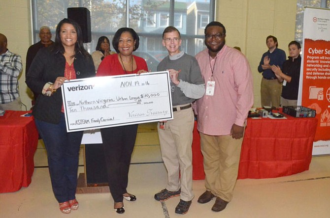 Verizon presents a $10,000 sponsorship check to the Northern Virginia Urban League (NOVAUL) for the technology expo; from left are Tracey Walker, Board Chair - NOVAUL; Lavern Chatman, Director, Fund Development - NOVAUL; Douglas E. Brammer, Manager of Government Affairs - Verizon; and Jamil Smart, President/CEO - Smart Learning Solutions.