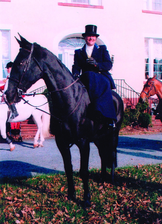 Potomac Hunt member Sarah O’Halloran, one of the few hunt members who ride side-saddle, is in formal hunting attire for the annual Thanksgiving Day hunt with her mount “Jeeves.” 