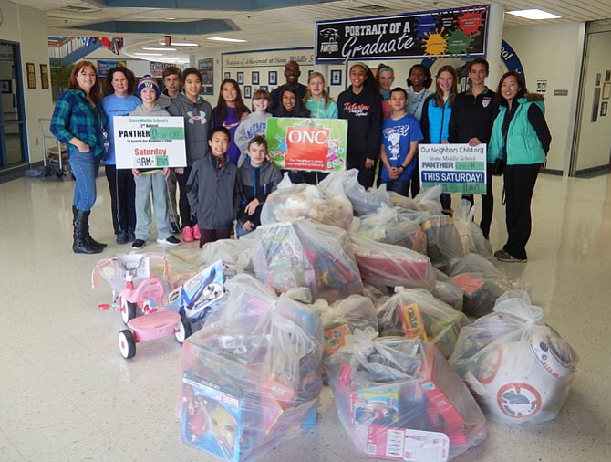 Last Saturday, Dec. 3, students in Stone Middle School’s National Junior Honor Society held a Panther Drop-Off gift collection for Our Neighbor’s Child. Community members brought donations of brand-new toys, books, games and clothing to the school, and the students packaged it all up and loaded it in a truck for transport to ONC’s warehouse.