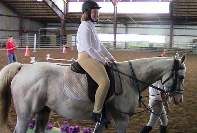 Nicole Springer rides a horse named Max at the SPIRIT Equestrian Program.
