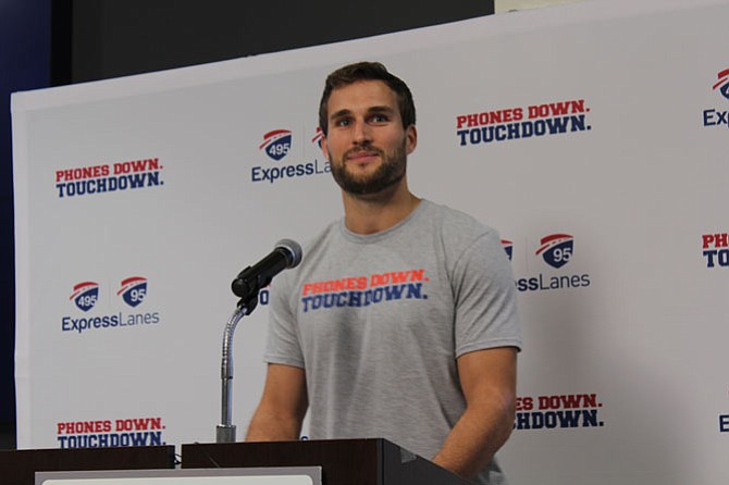 Washington Redskins starting quarterback Kirk Cousins answers questions from the media during a press conference for the campaign’s kickoff on Nov. 29. Drivers who share the “Phones Down. Touchdown.” graphic on social media with the hashtag #PhoneDownTouchdown will be entered to win a month of free travel on the 495 and 95 Express Lanes. 
