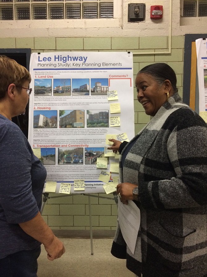 Sara Rubida (left) and WIllie Jackson (right) look over the maps at Lee Highway planning meeting. 