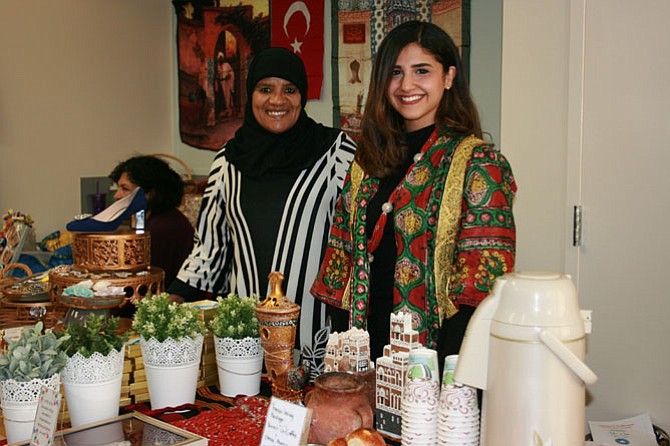 Fathepla Baaki (left) and Sukaina Alshami at the Yemeni stand where rolls and coffee were offered.