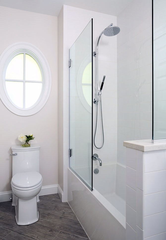 Designer Samantha Klickna removed a wall in this bathroom that divided the vanity from the tub and toilet, allowing an abundance of light to flow into the space. 