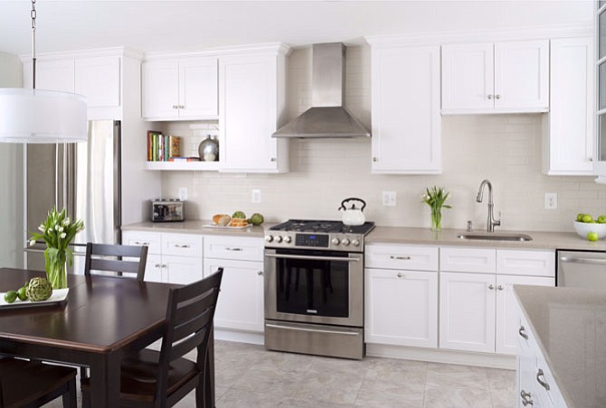 This budget-friendly kitchen by Elena Eskandari includes finishes such as quartz countertops and ceramic backsplash tile with crackled glazing.