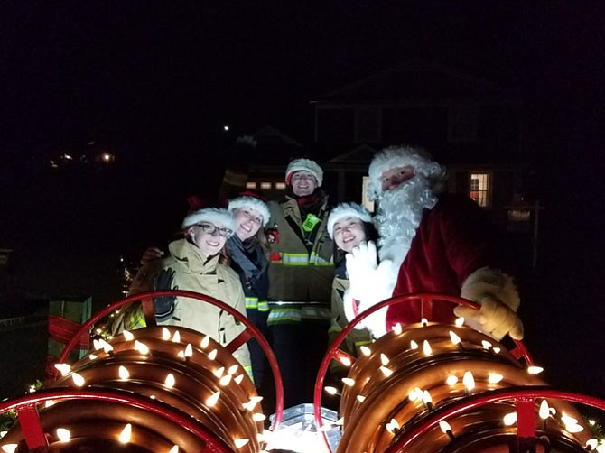 Santa and his elves prepare for the night ride through Vienna on Dec. 10, the second Santa Run of the day. The Santa Run is an annual tradition run by the Vienna Volunteer Fire Department; volunteers brave the frigid temperatures to ensure Vienna children meet Santa in-person.