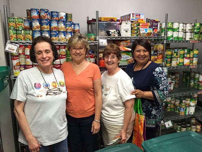 From left: Sheila Barrett, Penny Britt, Martha Jenkins and Minnie Orozco finished filling the shelves at the Cornerstones Reston Pantry.