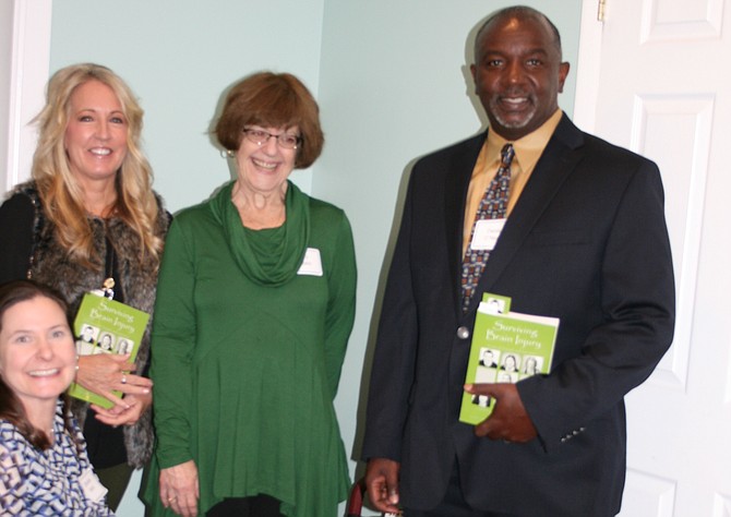 From left: Danielle Houston Karst (kneeling), Molly Raymond, Toni Popkin, and Derek O’Neal at the November launch of “Surviving Brain Injury” hosted by Brain Injury Services.
