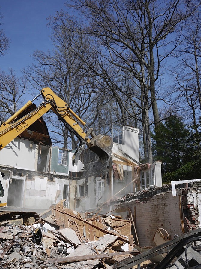 One way of tearing down a house in Arlington is to demolish it, sending tons of slate, hardwood, granite, glass, and appliances into a landfill. It takes about two days and costs about $25,000. 