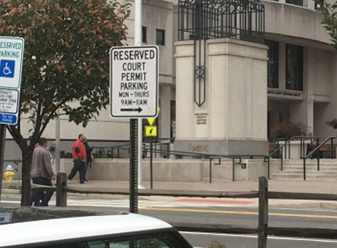 Towing signs marked outside of Arlington Courthouse.