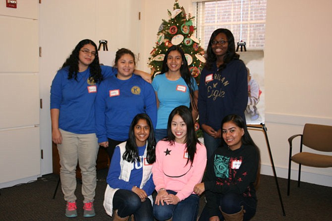 T.C. Williams Key Club members at Deck the Halls: Top from left are Nercy Paz, Emily Rodriguez, Roxana Ramirez and Ekua Biney; bottom from left are Sidrah Hamid, Cindy Do, and Maimona Maham.