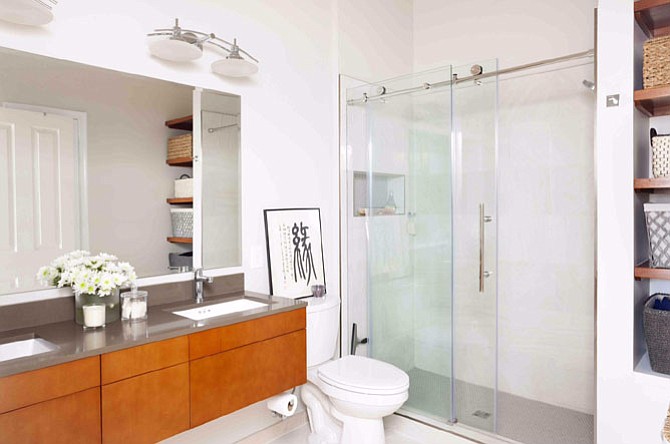 Creating multiple depth shelves such as those in this Arlington bathroom by Case/Fred Home Improvement helps with organization.
