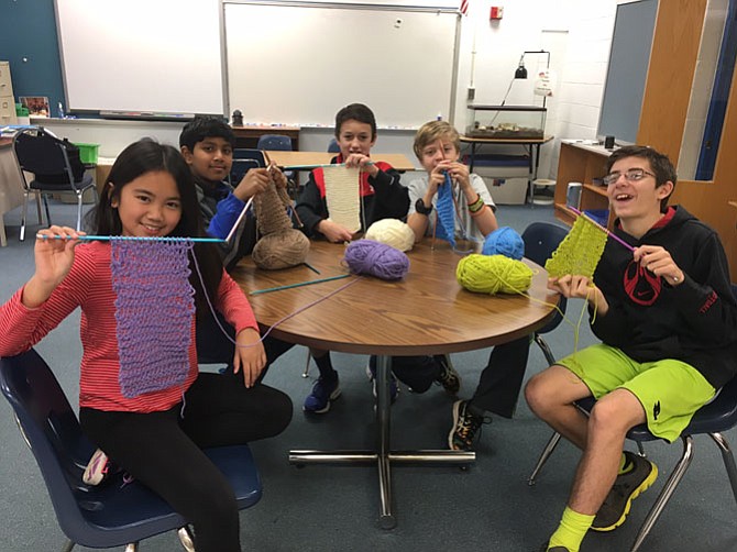 Churchill Road sixth graders Angelica Carlos, Pranav Anumandla, Mack Koopmen, Joseph Racich and Jake Loadwick with the scarves they made for a local homeless shelter.
