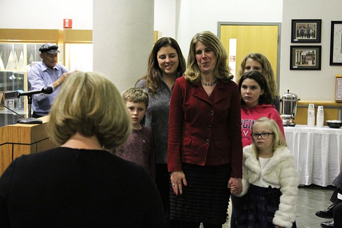 Vice Mayor Jennifer Baker stands with her family as she is administered her oath of office by Viki Wellershaus, the town’s clerk.
