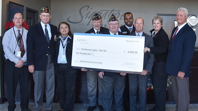 Daniel Gillespie, Robert Thompson and David Kirby of The American Legion  Wayne M. Kidwell  Post 184 accept a $5,000 donation check from Signature Flight Support, a BBA Aviation Company. Pictured, from left:   Wesley Lowery, Signature Flight Support; Daniel Gillespie, Post 184 Finance Office; Parwin Kurasz, Signature Flight Support, Robert Thompson, Post 184 1st Vice Commander; David Kirby, Post 184 Commander; Jean Best, Robert Grant, Katrin Phillips, and Tony Wright (Signature Flight Support). 