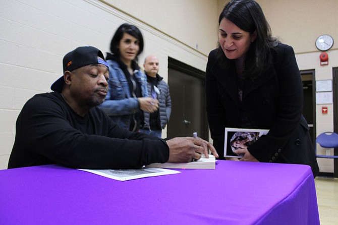Muna Shami of McLean gets her book, “Fight the Power: Rap, Race, and Reality” signed by Chuck D.
