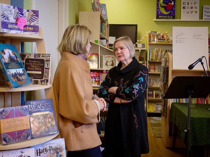 Arlington resident Sheridan Collins speaks with Katherine Young at the One More Page bookstore event. 