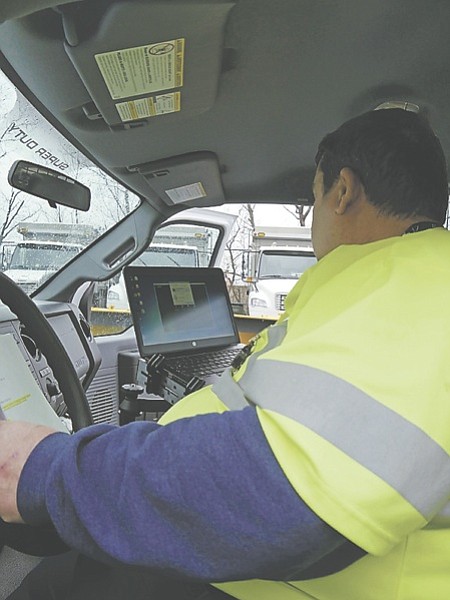 Bill Jones checks his map on the computer located in his truck before heading to the emergency site to mark the sewer lines. Jones is utilities coordinator for Public Works Services for the City Department of Transportation and Environmental Services.