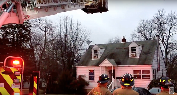 Firefighters used a ladder to get a fire hose to the second-floor attic to extinguish the fire.