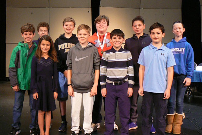 Eighth-grader and Arlington resident Chris Stewart (pictured in middle with his medal) won the school's Bee for the third consecutive year and now advances to the state level.