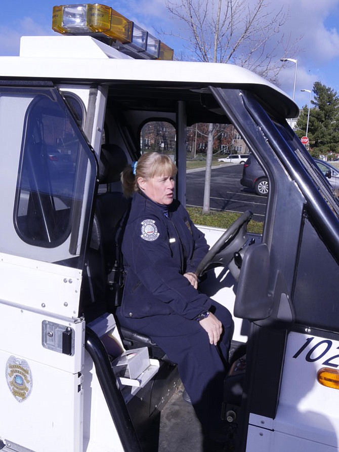 Cheryl Fuller, parking enforcement officer for the City of Alexandria, climbs into her one-person Go-4 and heads to her monthly assigned zone. She has been a parking enforcement officer for 20 years.