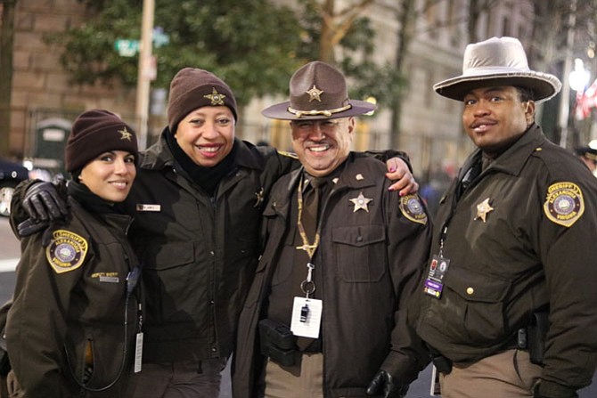 Alexandria Sheriff’s Office deputies Nora Jones, Myrna Juarez, Ernesto Arroyo and Samuel Clark gather before the start of Inauguration Day activities Jan. 20. The deputies were among 13 ASO deputies sworn in to assist with security throughout the day. Photo by Patrick Cushing