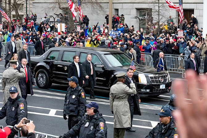 Fairfax County police officers, in foreground, provide security to President Donald Trump’s limousine as it makes its way through the streets of Washington during the Inauguration Day parade Jan. 20. More than 3,000 officers from across the country were sworn in to assist with Inauguration activities, including 105 officers from the Fairfax County Police Department.
