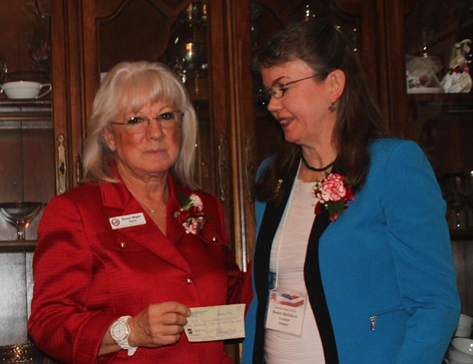 On behalf of the Republican Women of Clifton, President Bonnie Burkhardt (right) presents a $500 check to Susan Wight in support of the Tragedy Assistance Program for Survivors.