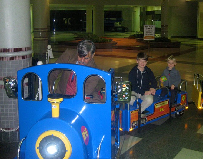 Tariq Kahn drives the train at Landmark Mall, carrying  Sawyer and Max McElhatton. The photo was taken one day before Khan must leave the mall on Jan. 30.