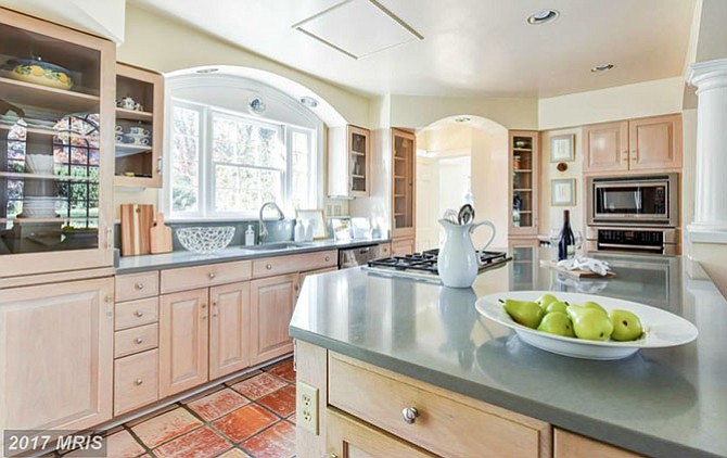 Floor-to-ceiling Palladian windows allow an abundance of light to stream into the kitchen of this Alexandria home. 