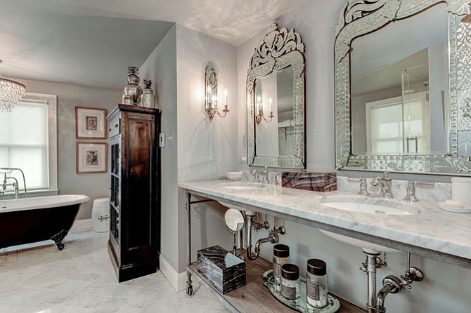 The master bathroom in this Fairfax home features Carrera marble, radiant heated floors and a large, frameless glass shower.